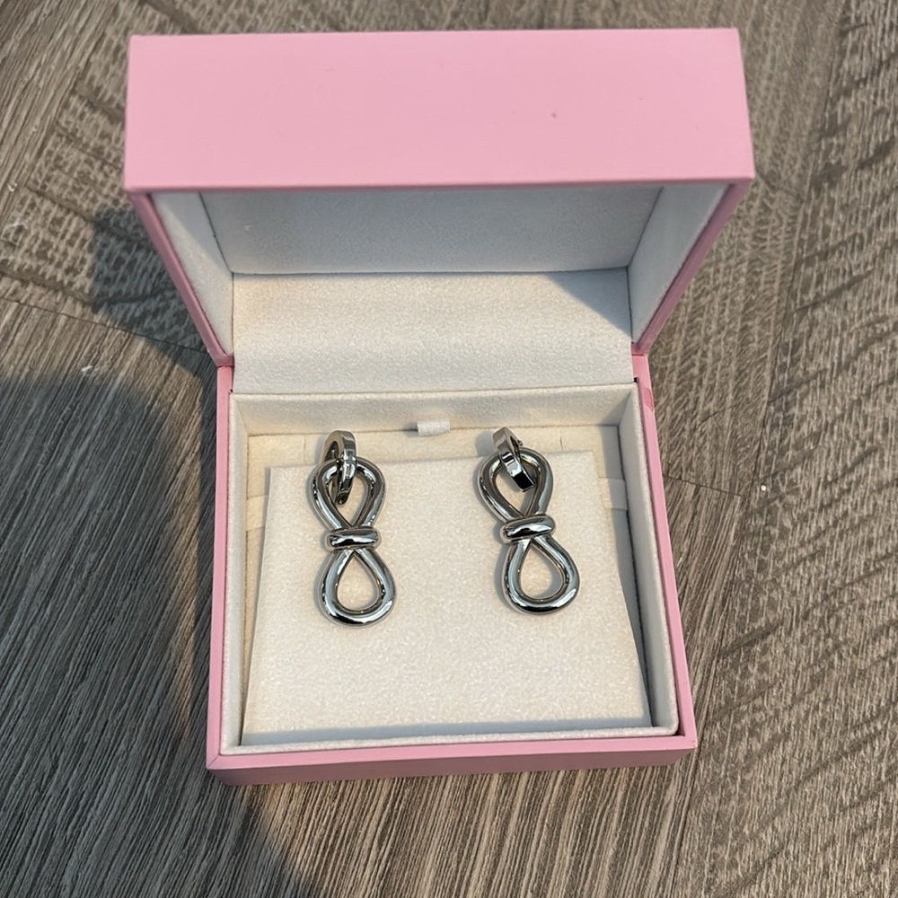 Mach and Mach silver bow earrings
